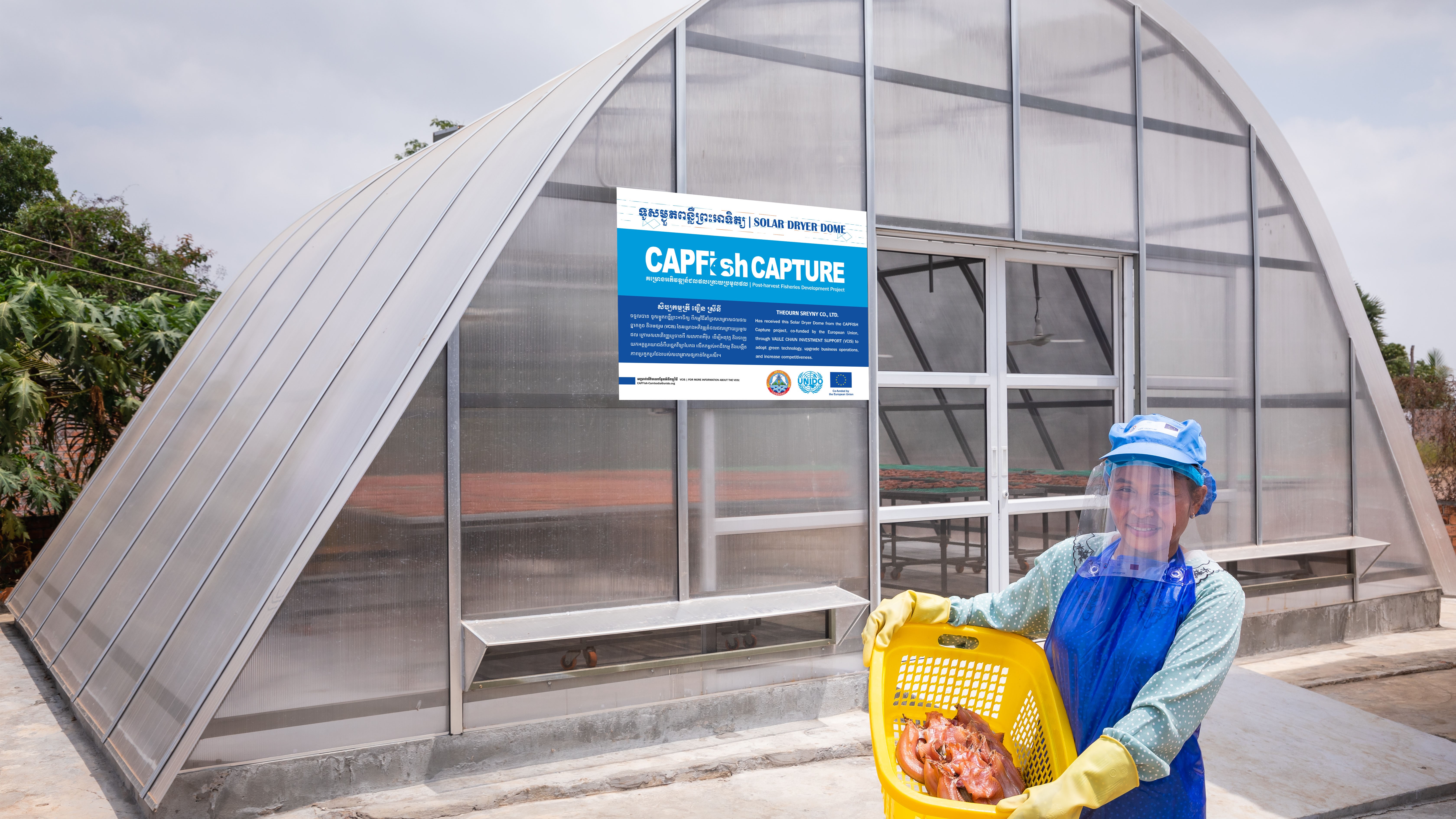 Lim Ponny with dried fish from her solar dryer dome provided by the CAPFISH-Capture project, co-funded by the EU